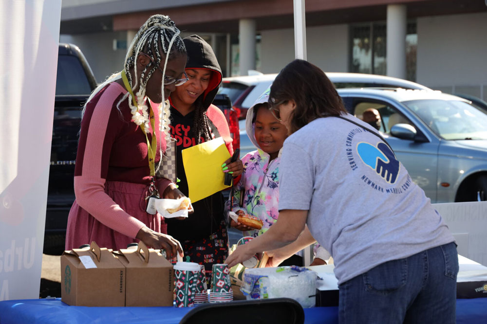 We Benefit Children charitable organization. Volunteer talking to a group.