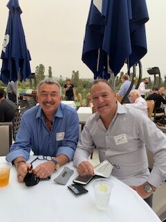 two smiling men at an event, charity connections luncheon