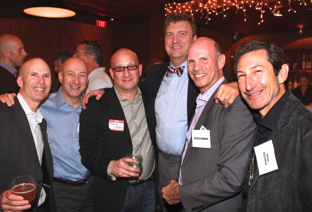 a group of men in dress shirts attending an event