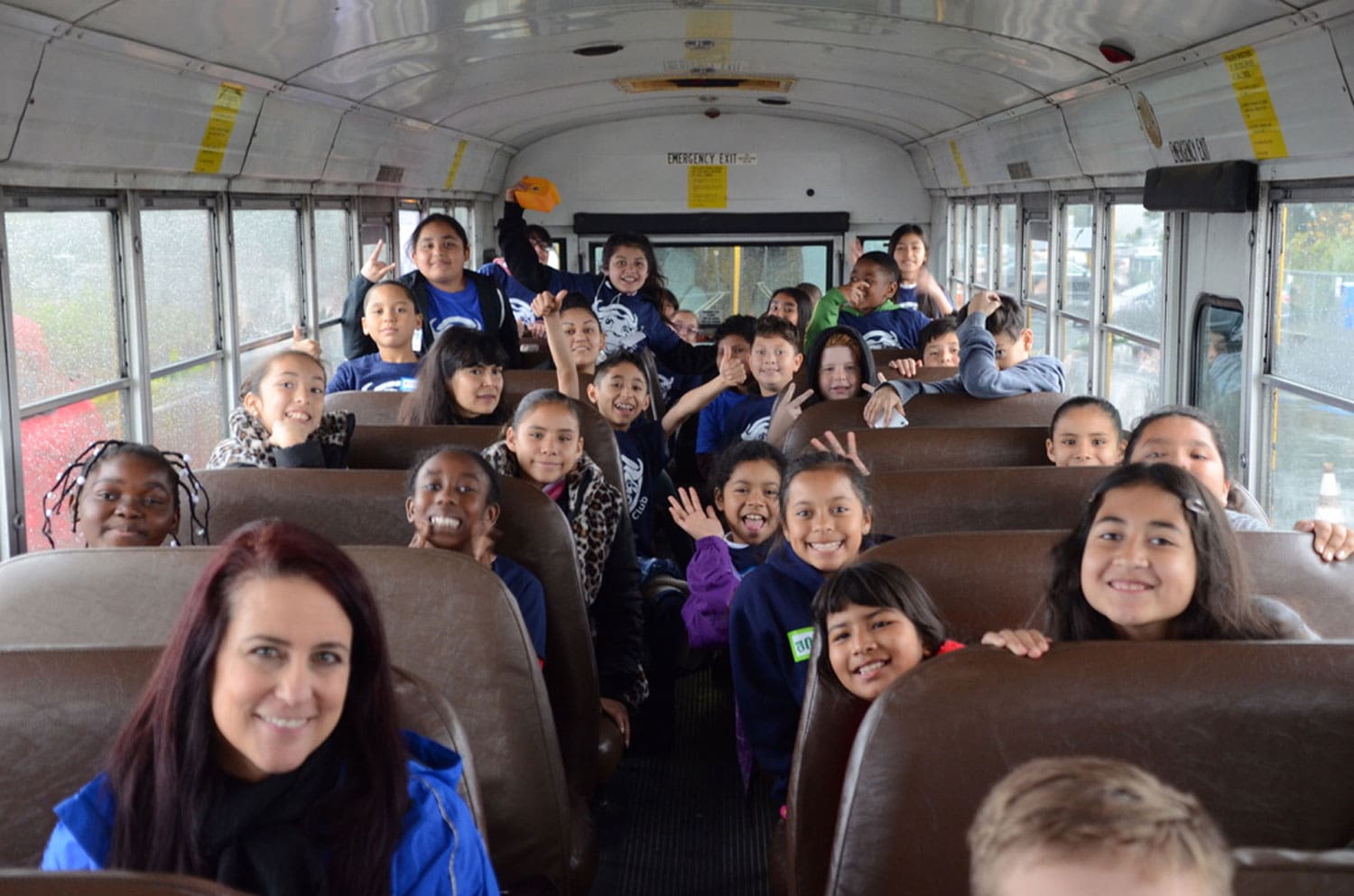 contact us we benefit children. children on a bus, petersen automotive field trip
