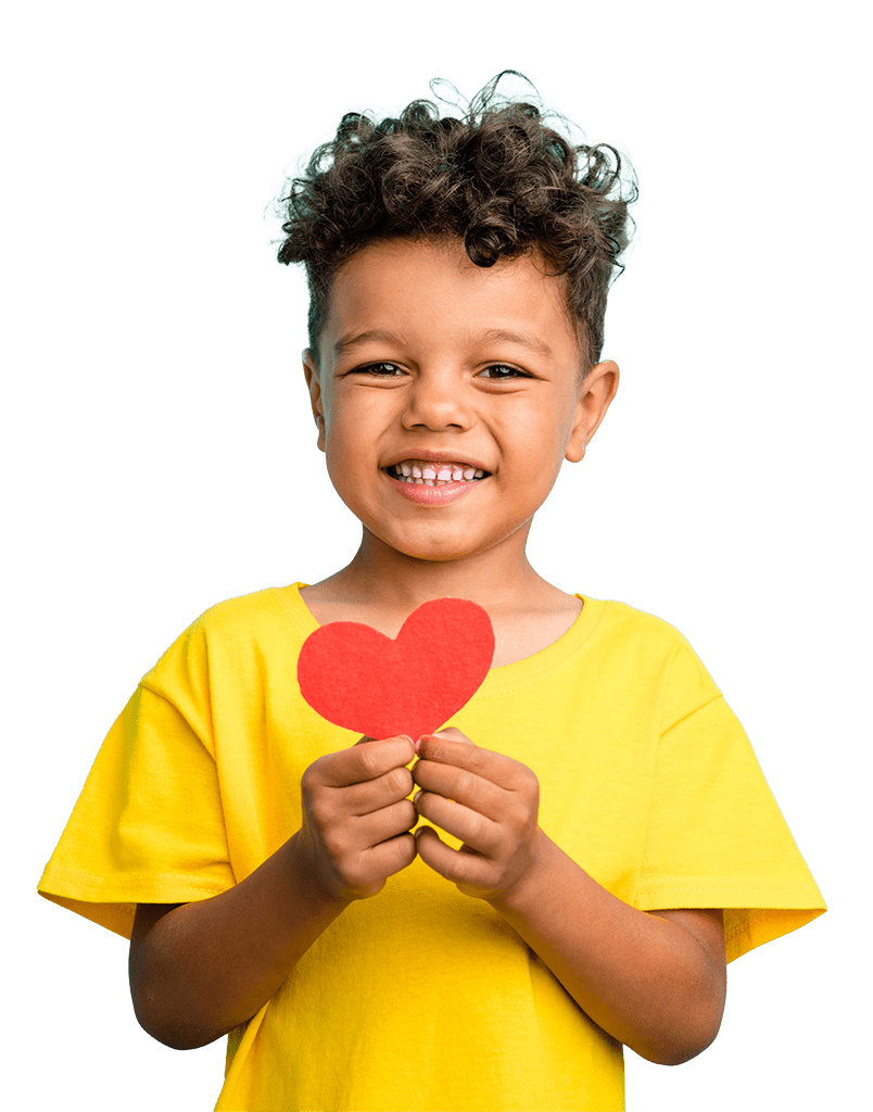 boy in yellow shirt holding a paper heart. We Benefit Children