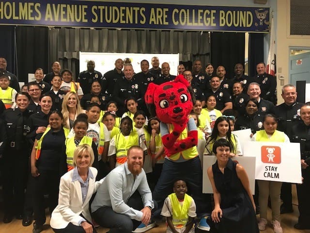 group of kids and police officers at safety event
